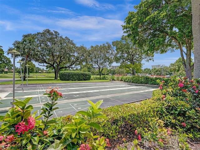605 Oaks Dr Unit 309, Pompano Beach, FL 33069 - view of community with shuffleboard and uncovered parking
