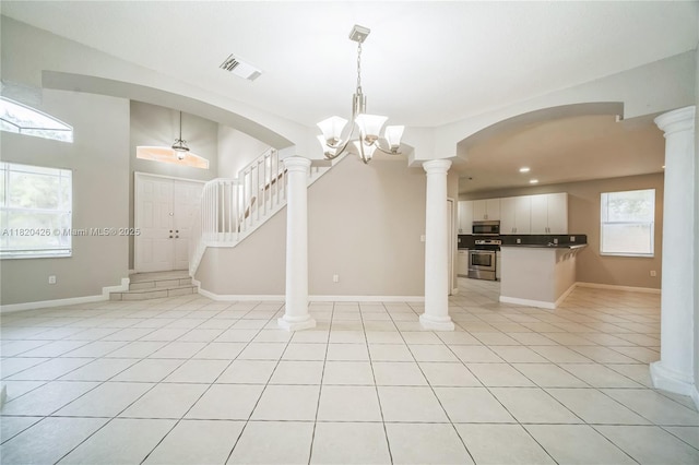 16313 SW 66th St, Miami, FL 33193 - foyer entrance with light tile patterned floors, arched walkways, stairs, recessed lighting, and decorative columns