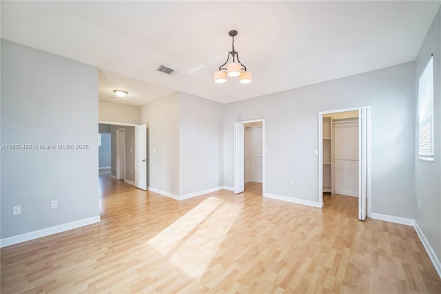 16313 SW 66th St, Miami, FL 33193 - empty room with light wood finished floors and a chandelier