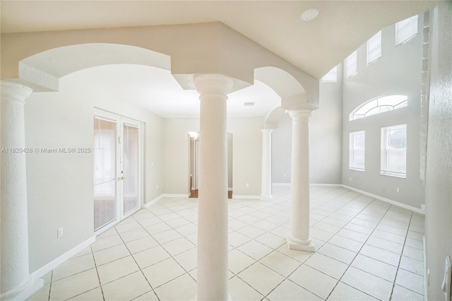 16313 SW 66th St, Miami, FL 33193 - empty room featuring light tile patterned floors, ornate columns, arched walkways, and vaulted ceiling