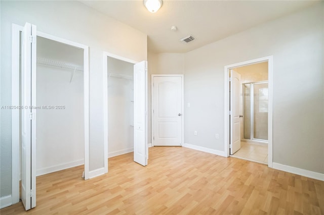 16313 SW 66th St, Miami, FL 33193 - unfurnished bedroom with multiple closets, light wood-style floors, and ensuite bath