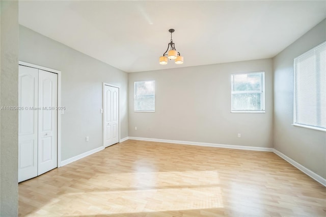 16313 SW 66th St, Miami, FL 33193 - empty room featuring light wood finished floors, plenty of natural light, vaulted ceiling, and a chandelier