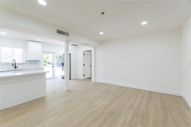 1167 NW 9th Ave, Fort Lauderdale, FL 33311 - unfurnished living room with recessed lighting and light wood finished floors