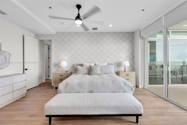 104000 Overseas Hwy Unit 5, Key Largo, FL 33037 - bedroom with wallpapered walls, an accent wall, access to exterior, light wood finished floors, and recessed lighting
