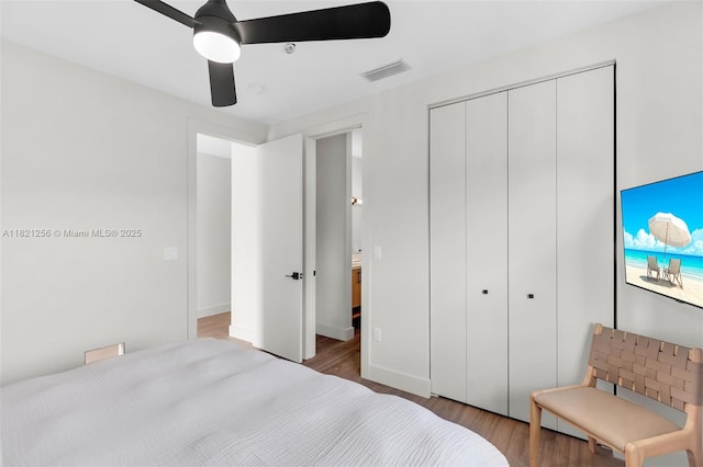 104000 Overseas Hwy Unit 5, Key Largo, FL 33037 - bedroom with wood finished floors, a closet, and a ceiling fan
