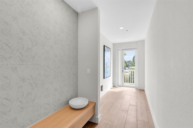 104000 Overseas Hwy Unit 5, Key Largo, FL 33037 - hallway with light wood-style floors and recessed lighting