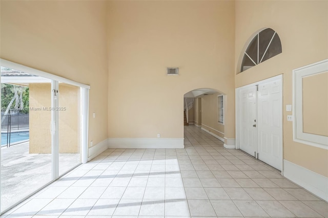 18043 SW 149th Pl, Miami, FL 33187 - foyer featuring a high ceiling, light tile patterned floors, and arched walkways