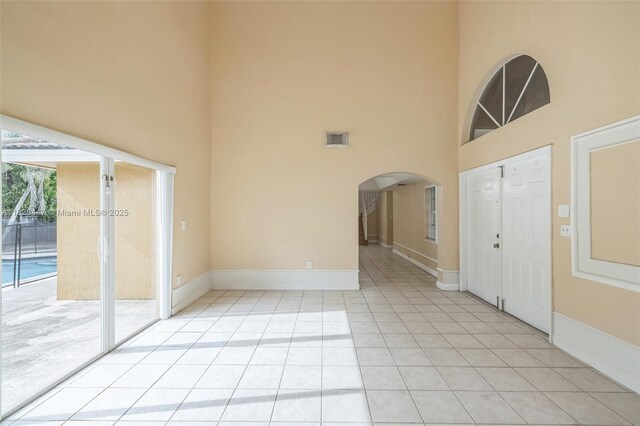 18043 SW 149th Pl, Miami, FL 33187 - foyer featuring a high ceiling, light tile patterned floors, and arched walkways