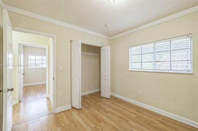 18043 SW 149th Pl, Miami, FL 33187 - unfurnished bedroom featuring light wood-type flooring, a textured ceiling, ornamental molding, and a closet