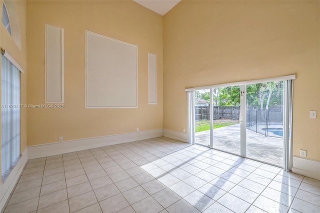 18043 SW 149th Pl, Miami, FL 33187 - empty room with tile patterned floors and a towering ceiling
