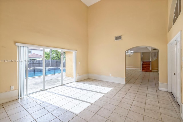 18043 SW 149th Pl, Miami, FL 33187 - unfurnished room with a high ceiling, arched walkways, and light tile patterned floors