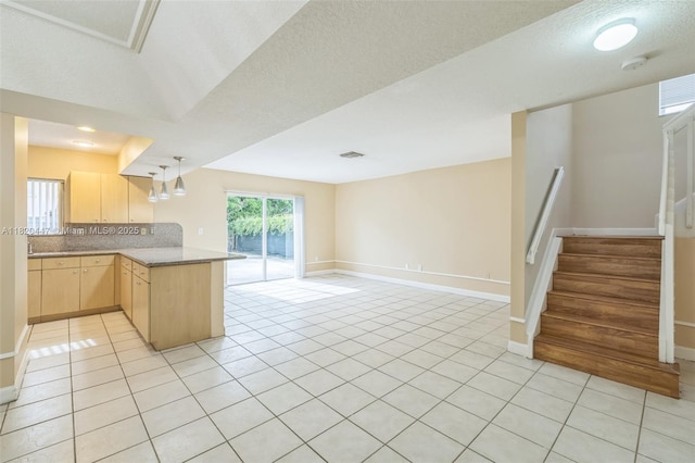 18043 SW 149th Pl, Miami, FL 33187 - kitchen featuring light brown cabinets, a peninsula, open floor plan, light tile patterned floors, and light countertops