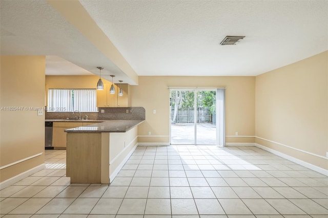 18043 SW 149th Pl, Miami, FL 33187 - kitchen with a peninsula, tasteful backsplash, light tile patterned flooring, dishwasher, and hanging light fixtures