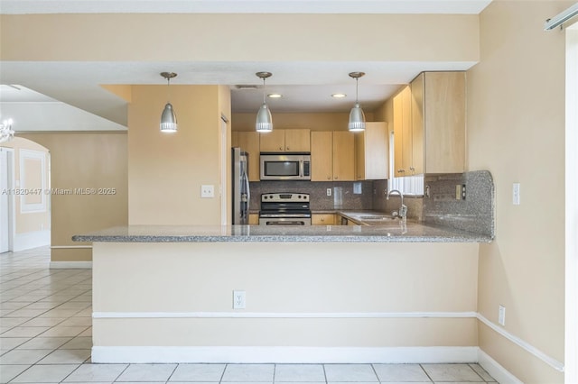 18043 SW 149th Pl, Miami, FL 33187 - kitchen featuring stainless steel appliances, backsplash, light brown cabinets, a peninsula, and light tile patterned floors