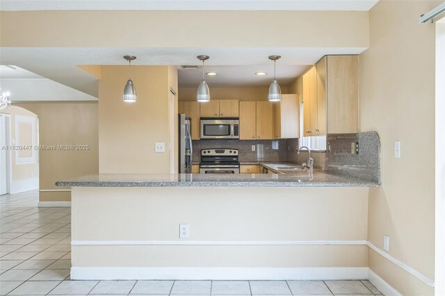 18043 SW 149th Pl, Miami, FL 33187 - kitchen featuring stainless steel appliances, backsplash, light brown cabinets, a peninsula, and light tile patterned floors