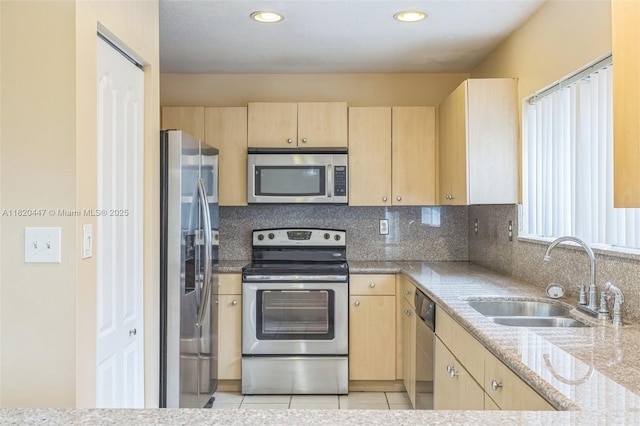 18043 SW 149th Pl, Miami, FL 33187 - kitchen with stainless steel appliances, light brown cabinets, tasteful backsplash, recessed lighting, and light tile patterned flooring