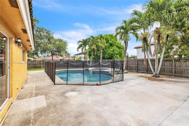 18043 SW 149th Pl, Miami, FL 33187 - view of swimming pool with a fenced backyard, a patio, and a pool with connected hot tub