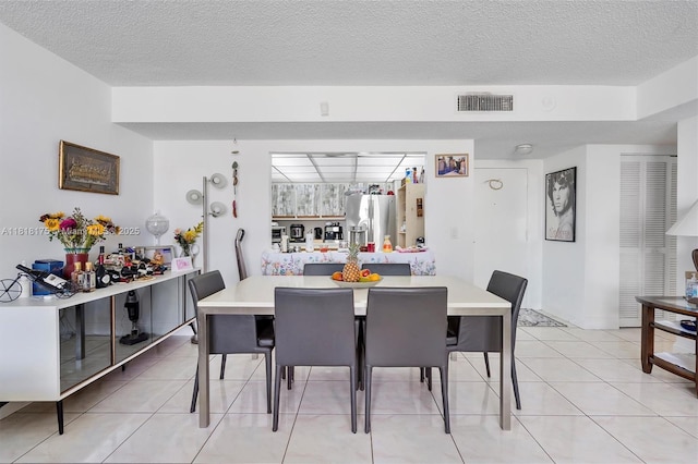 13499 Biscayne Blvd Unit 406, North Miami, FL 33181 - dining space featuring a textured ceiling and light tile patterned floors