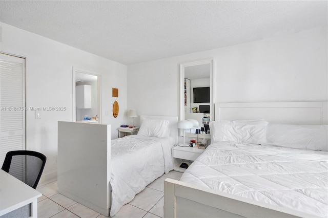 13499 Biscayne Blvd Unit 406, North Miami, FL 33181 - bedroom featuring light tile patterned floors and a textured ceiling