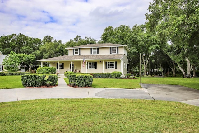 4691 Long Lake Dr, Fort Myers, FL 33905 - view of front facade with a front yard, a porch, and a shingled roof