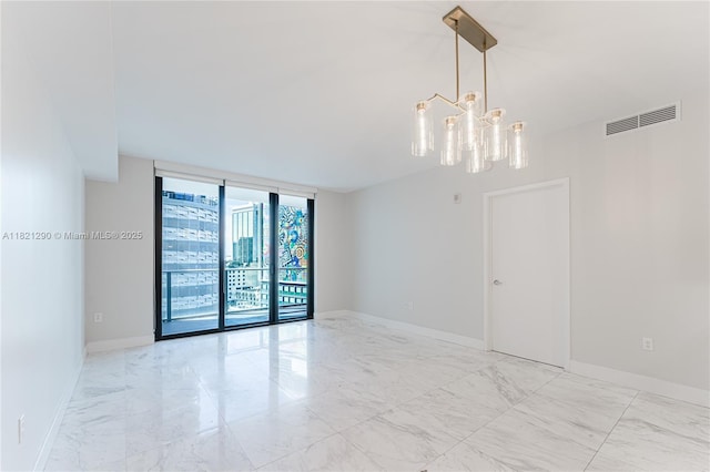 1010 Brickell Ave Unit 1409, Miami, FL 33131 - spare room with light marble finish floors, a chandelier, and expansive windows