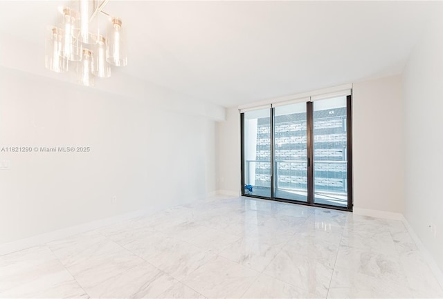 1010 Brickell Ave Unit 1409, Miami, FL 33131 - unfurnished room featuring a chandelier, marble finish flooring, and a wall of windows