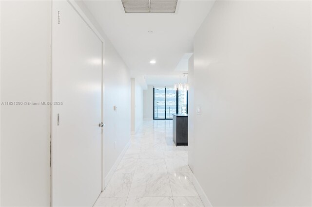 1010 Brickell Ave Unit 1409, Miami, FL 33131 - hall with light marble finish flooring, a wall of windows, and recessed lighting