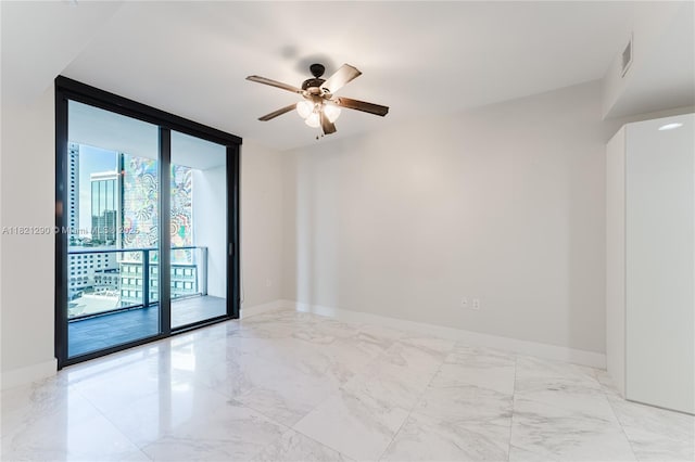 1010 Brickell Ave Unit 1409, Miami, FL 33131 - empty room featuring floor to ceiling windows, ceiling fan, and marble finish flooring