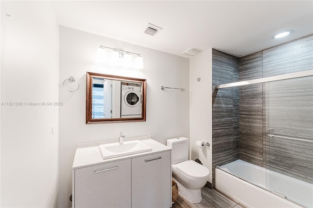 1010 Brickell Ave Unit 1409, Miami, FL 33131 - full bath with vanity, enclosed tub / shower combo, estacked washer and dryer, and wood finished floors