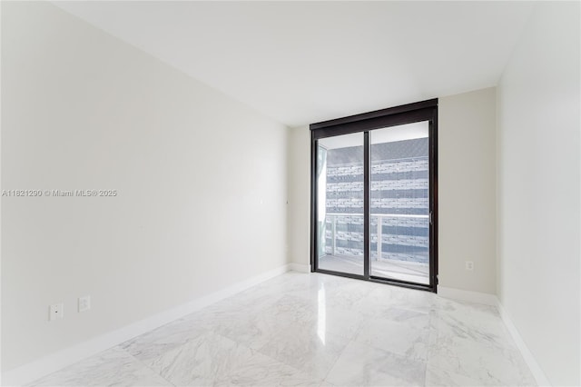 1010 Brickell Ave Unit 1409, Miami, FL 33131 - spare room with marble look tiles and a wall of windows
