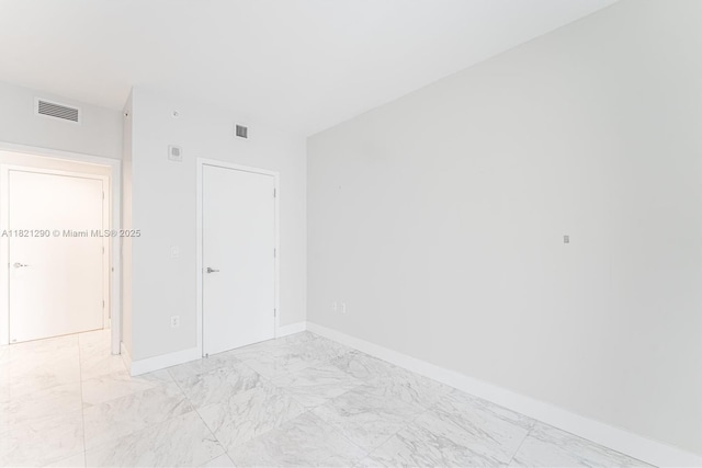 1010 Brickell Ave Unit 1409, Miami, FL 33131 - unfurnished room featuring light marble finish flooring and baseboards
