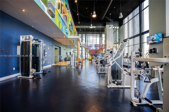 1010 Brickell Ave Unit 1409, Miami, FL 33131 - exercise room featuring a high ceiling and a wall of windows