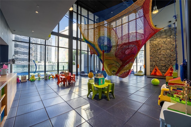 1010 Brickell Ave Unit 1409, Miami, FL 33131 - game room with expansive windows, a towering ceiling, plenty of natural light, and a view of city