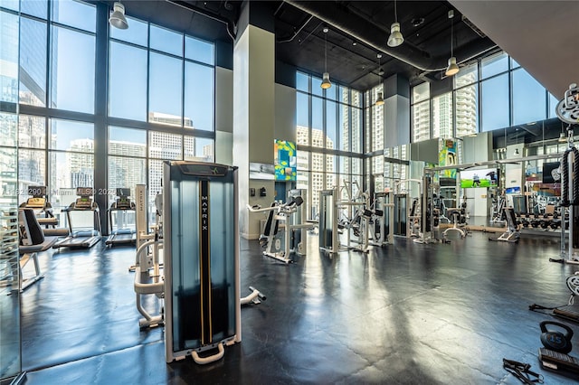 1010 Brickell Ave Unit 1409, Miami, FL 33131 - gym featuring a high ceiling, a city view, and floor to ceiling windows