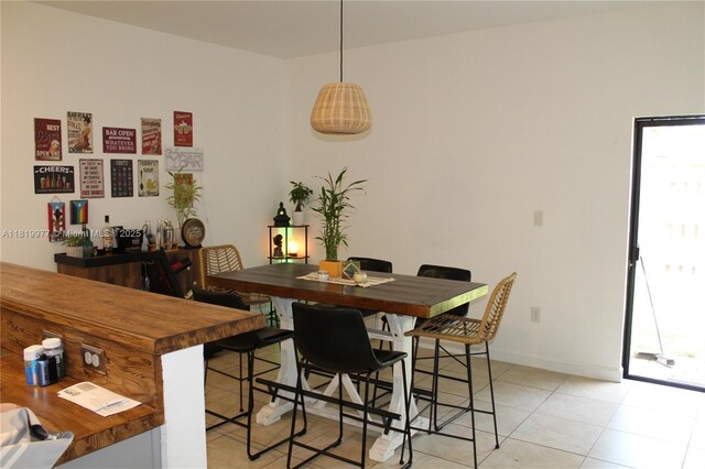 581 SE 32nd Ter, Homestead, FL 33033 - dining area featuring light tile patterned flooring and baseboards