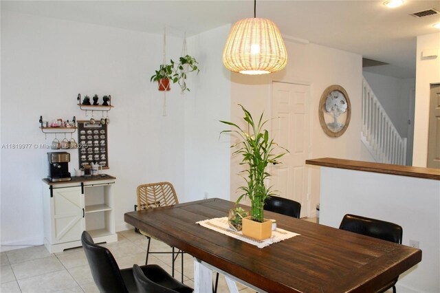 581 SE 32nd Ter, Homestead, FL 33033 - dining room featuring light tile patterned floors and stairway