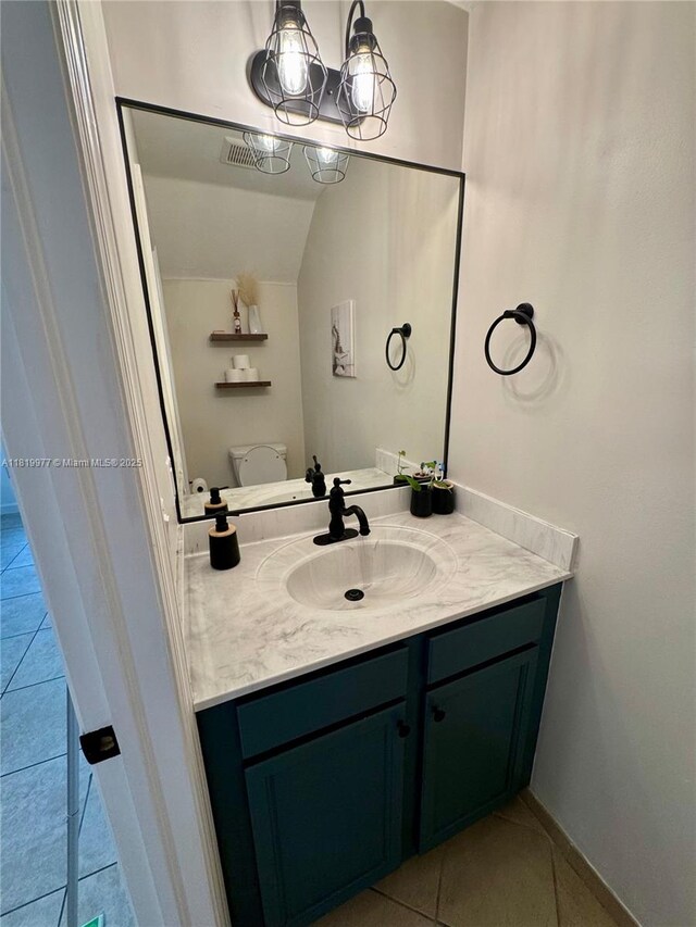 581 SE 32nd Ter, Homestead, FL 33033 - bathroom with vanity, tile patterned flooring, a chandelier, and vaulted ceiling