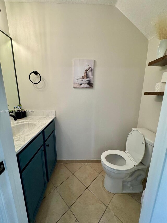 581 SE 32nd Ter, Homestead, FL 33033 - half bath with vanity, lofted ceiling, and tile patterned floors