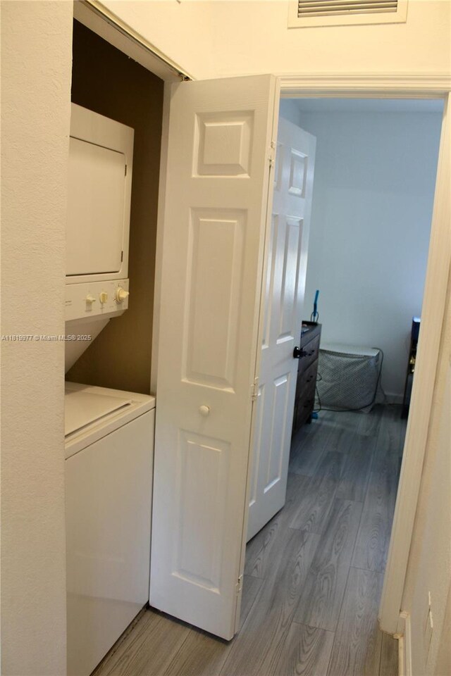 581 SE 32nd Ter, Homestead, FL 33033 - laundry room featuring estacked washer and dryer and wood finished floors