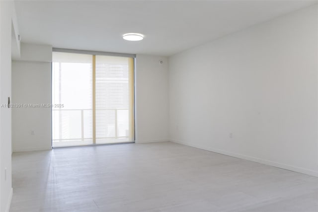 1000 Brickell Plz Unit 3703, Miami, FL 33131 - unfurnished room featuring light wood finished floors and expansive windows