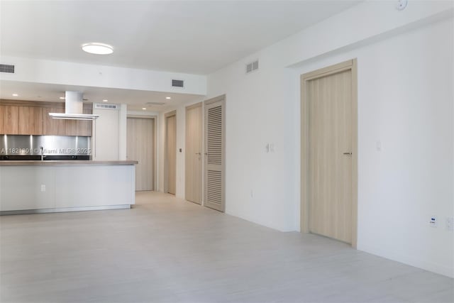 1000 Brickell Plz Unit 3703, Miami, FL 33131 - unfurnished living room with light wood finished floors and recessed lighting