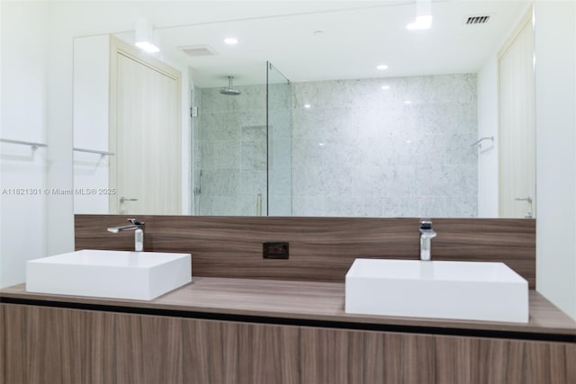 1000 Brickell Plz Unit 3703, Miami, FL 33131 - bathroom with double vanity and a tile shower