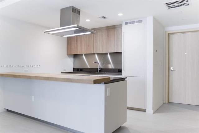 1000 Brickell Plz Unit 3703, Miami, FL 33131 - kitchen featuring modern cabinets, island range hood, recessed lighting, and a peninsula