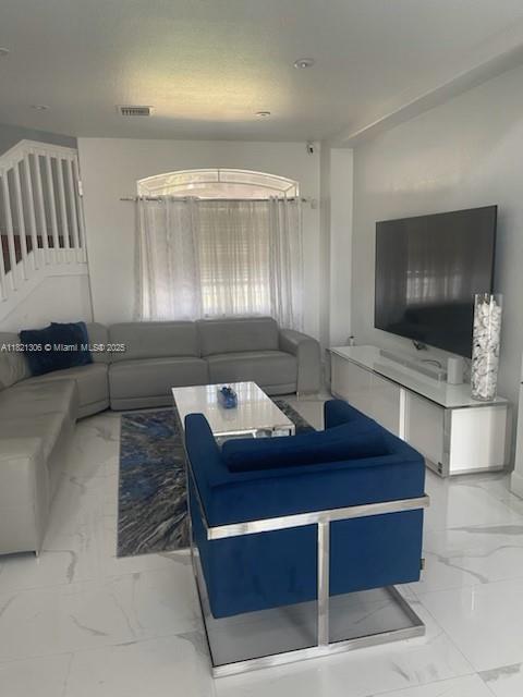 8770 SW 204th St, Cutler Bay, FL 33189 - living area featuring light marble finish floors