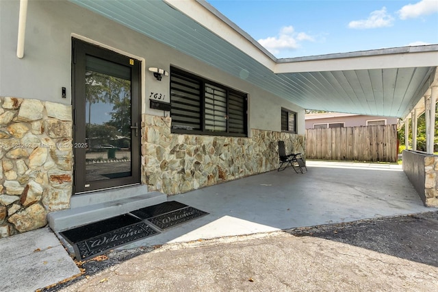 7631 Miramar Pkwy, Miramar, FL 33023 - property entrance featuring stone siding, a carport, and stucco siding