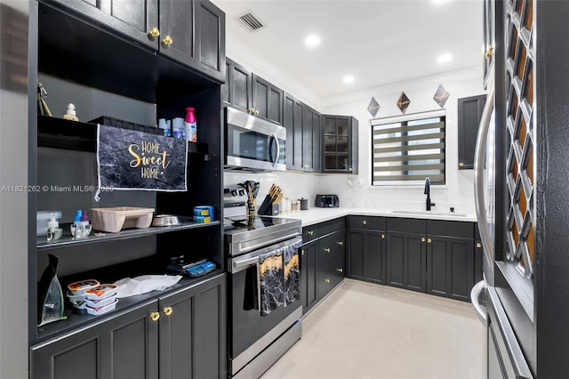 7631 Miramar Pkwy, Miramar, FL 33023 - kitchen with appliances with stainless steel finishes, glass insert cabinets, crown molding, and light countertops