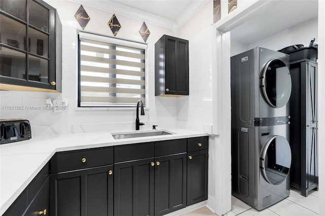 7631 Miramar Pkwy, Miramar, FL 33023 - laundry area featuring stacked washer / dryer, ornamental molding, and light tile patterned floors