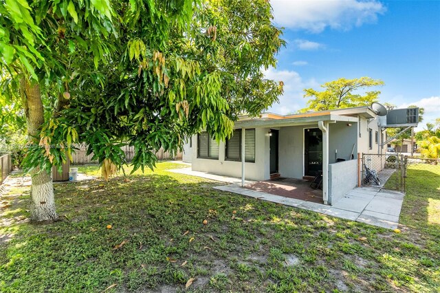 7631 Miramar Pkwy, Miramar, FL 33023 - rear view of house featuring a fenced backyard, stucco siding, a gate, and a patio