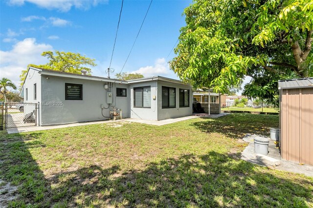 7631 Miramar Pkwy, Miramar, FL 33023 - rear view of property with stucco siding and a gate