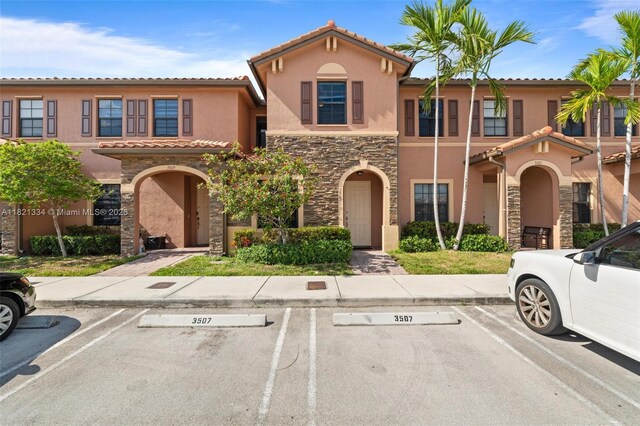 3507 W 89th Pl, Hialeah, FL 33018 - view of front of home featuring stone siding, stucco siding, and uncovered parking